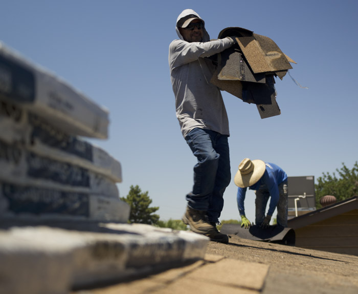 Roof replacement contractor in Phoenix AZ installing new shingle roofing system